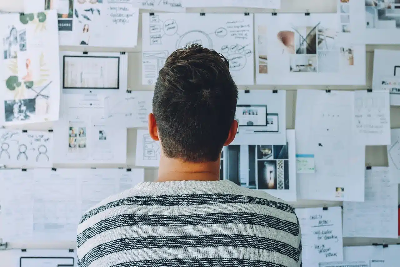 A man considering the difference between research studies and surveys